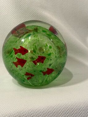 Glass sphere with goldfish, plants, and green background.  Paperweight, decor